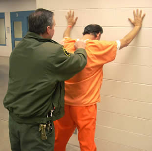 inmate being frisked